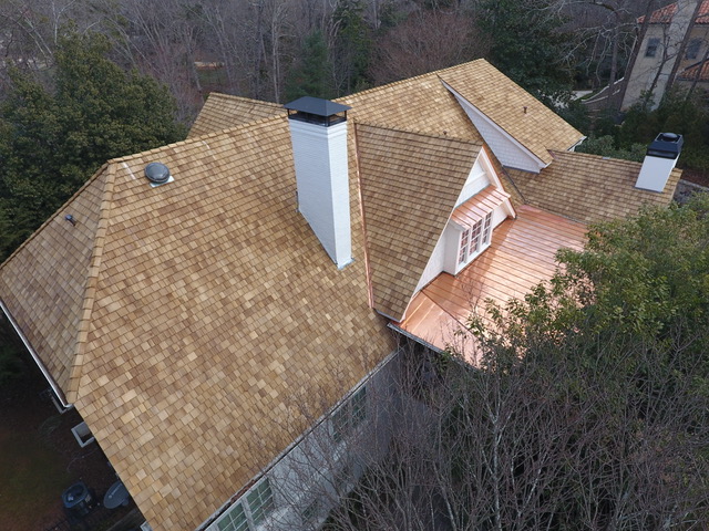 Cedar shingle roof with copper accents on an Atlanta home